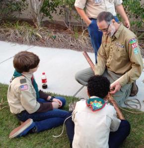 Link to: Larger Image Teaching the conventional Diagonal Lashing to Boy Scouts at a troop meeting.