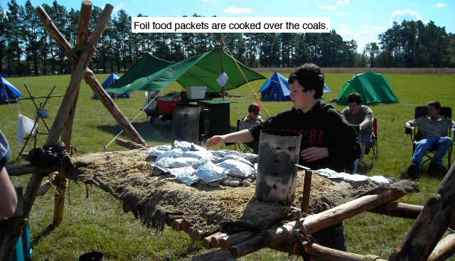 Foil food packets are cooked over the coals on a Chippewa Kitchen