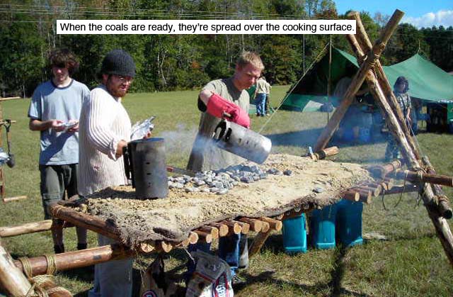 Pouring out the Charcoal. When the coals are ready, they're spread over the cooking surface of the Chippewa Kitchen.